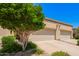 Driveway leading up to garages, framed by desert landscaping under a bright, sunny sky at 6730 E Hermosa Vista Dr # 72, Mesa, AZ 85215