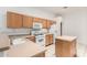 Functional kitchen featuring appliances, a kitchen island, and plenty of cabinet space at 6730 E Hermosa Vista Dr # 72, Mesa, AZ 85215