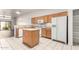 Spacious kitchen with appliances, an island, and adjacent living room area at 6730 E Hermosa Vista Dr # 72, Mesa, AZ 85215
