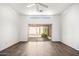 Bright living room with laminated wood flooring, a modern ceiling fan, and sliding doors to the patio at 6730 E Hermosa Vista Dr # 72, Mesa, AZ 85215