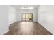 Bright living room with laminated wood flooring, a modern ceiling fan, and sliding doors to the patio at 6730 E Hermosa Vista Dr # 72, Mesa, AZ 85215