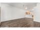 Open living room featuring wood floors, ceiling fan, and a view into the kitchen at 6730 E Hermosa Vista Dr # 72, Mesa, AZ 85215