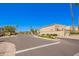 Community street view showing tan homes, sidewalks, palm trees, and desert landscaping at 6730 E Hermosa Vista Dr # 72, Mesa, AZ 85215