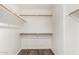 A walk-in closet featuring wood-look flooring and built-in shelving on three sides at 6730 E Hermosa Vista Dr # 72, Mesa, AZ 85215