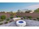 Relaxing backyard retreat featuring a modern fire pit, gravel landscaping, and a cozy built-in bench for outdoor enjoyment at 7415 W Lisbon Ln, Peoria, AZ 85381