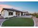 Well-maintained backyard featuring a manicured lawn, patio, fire pit, and outdoor cooking area, perfect for outdoor living at 7415 W Lisbon Ln, Peoria, AZ 85381
