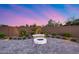 A cozy backyard offers an inviting fire pit and stylish landscaping for tranquil outdoor living at 7415 W Lisbon Ln, Peoria, AZ 85381