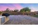 Spacious backyard boasts an outdoor cooking area, paving stones, manicured lawn, and desert landscaping for relaxation at 7415 W Lisbon Ln, Peoria, AZ 85381