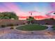 Backyard oasis with a putting green and elegant landscaping for leisure and recreation at 7415 W Lisbon Ln, Peoria, AZ 85381