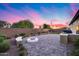 Enjoy outdoor living on this backyard with a fire pit, covered patio, and lush, landscaped lawn at 7415 W Lisbon Ln, Peoria, AZ 85381