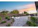 Expansive backyard with a fire pit, built-in seating, a charming lawn, and an outdoor cooking area for entertainment at 7415 W Lisbon Ln, Peoria, AZ 85381