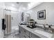 Bright bathroom with double vanity, stylish backsplash, and subway tile shower at 7415 W Lisbon Ln, Peoria, AZ 85381