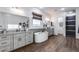 Luxurious bathroom featuring dual vanities, a soaking tub, and elegant fixtures with wood-look tile floors at 7415 W Lisbon Ln, Peoria, AZ 85381