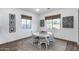 Charming dining area with a round table, natural light, and decorative window treatments at 7415 W Lisbon Ln, Peoria, AZ 85381