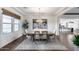 Elegant dining room with a large window, woven window shade and stylish pendant lighting at 7415 W Lisbon Ln, Peoria, AZ 85381