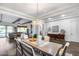 Open concept dining room showcasing a spacious wooden table, elegant lighting, and seamless flow to the living area at 7415 W Lisbon Ln, Peoria, AZ 85381