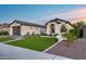 Charming single-story home with a manicured lawn, paved driveway, and inviting entrance and a two car garage at 7415 W Lisbon Ln, Peoria, AZ 85381