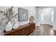 Inviting hallway with wooden floors, decorative console table, and modern art display at 7415 W Lisbon Ln, Peoria, AZ 85381