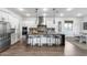 Modern kitchen with white cabinetry, large center island, stainless appliances, and stylish pendant lighting at 7415 W Lisbon Ln, Peoria, AZ 85381