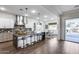 Modern kitchen featuring a large island with seating, stainless steel appliances, and a view of the dining area at 7415 W Lisbon Ln, Peoria, AZ 85381