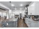 Modern kitchen with a large island, stainless steel appliances, and custom cabinetry, with open access to dining area at 7415 W Lisbon Ln, Peoria, AZ 85381