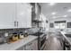 Well-equipped kitchen with stainless steel appliances, counter seating, and access to the dining area at 7415 W Lisbon Ln, Peoria, AZ 85381