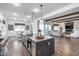 Open-concept kitchen featuring stainless steel appliances, a large island, and seamless flow to living area at 7415 W Lisbon Ln, Peoria, AZ 85381