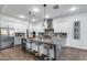 Spacious kitchen featuring a large island with seating, stainless steel appliances, and stylish pendant lighting at 7415 W Lisbon Ln, Peoria, AZ 85381