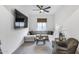 Comfortable living room with a sectional sofa, modern decor, a large TV, and a cozy atmosphere perfect for relaxation at 7415 W Lisbon Ln, Peoria, AZ 85381