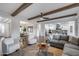 Comfortable living room with wooden beams and view to the kitchen and dining areas, perfect for entertaining guests at 7415 W Lisbon Ln, Peoria, AZ 85381