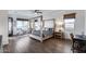 Tranquil bedroom with a four-poster bed, complemented by neutral tones and plenty of natural light at 7415 W Lisbon Ln, Peoria, AZ 85381