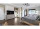 Inviting bedroom featuring a statement bed, wood-look tile floors, and access to sitting area and backyard at 7415 W Lisbon Ln, Peoria, AZ 85381