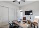 Cozy office featuring an open doorway, ceiling fan, modern desk, and two comfortable chairs at 7415 W Lisbon Ln, Peoria, AZ 85381