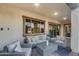 Covered patio with comfortable seating, and views of the lush backyard through large windows at 7415 W Lisbon Ln, Peoria, AZ 85381
