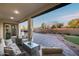 Inviting covered patio with plush seating, a coffee table, and access to an expansive backyard area at 7415 W Lisbon Ln, Peoria, AZ 85381