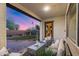 Charming covered patio offering a cozy seating area and views of the beautifully landscaped backyard with a lush lawn at 7415 W Lisbon Ln, Peoria, AZ 85381