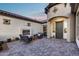 Beautiful outdoor patio with pavers, fireplace, and lounge furniture for relaxing and entertaining at 7415 W Lisbon Ln, Peoria, AZ 85381