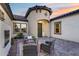 Charming patio with stylish outdoor seating and an inviting entrance turret under a colorful sky at 7415 W Lisbon Ln, Peoria, AZ 85381