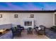 Outdoor patio features a modern fireplace, seating, and stylish pavers, creating an inviting space at 7415 W Lisbon Ln, Peoria, AZ 85381