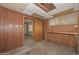 Unfinished basement with wood paneling, concrete floors and access to the main floor at 829 E Echo Ln, Phoenix, AZ 85020