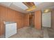 Unfinished basement featuring wood paneling, storage and laundry hookups at 829 E Echo Ln, Phoenix, AZ 85020