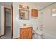 Standard bathroom with tiled bath and wood vanity, featuring essential amenities at 829 E Echo Ln, Phoenix, AZ 85020