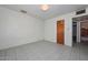 Bedroom featuring a tiled floor with a door leading into an attached bathroom at 829 E Echo Ln, Phoenix, AZ 85020