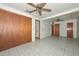 Spacious bedroom featuring tiled floors, a ceiling fan, and a sizable closet at 829 E Echo Ln, Phoenix, AZ 85020