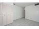 A simple bedroom featuring a closet and tiled floors in a neutral tone at 829 E Echo Ln, Phoenix, AZ 85020
