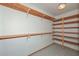 Walk-in closet with shelving, providing ample storage, tiled floors and lighting at 829 E Echo Ln, Phoenix, AZ 85020