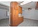 Kitchen storage unit with wood cabinets, open shelving, and skylight for natural light at 829 E Echo Ln, Phoenix, AZ 85020