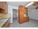 Cozy kitchen with wood cabinets and light countertops, ready for your personal touch at 829 E Echo Ln, Phoenix, AZ 85020