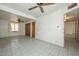 Neutral living room featuring tile floors, ceiling fan, and closet for storage at 829 E Echo Ln, Phoenix, AZ 85020