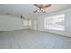 Spacious living room featuring tile floors, ceiling fans, and large windows at 829 E Echo Ln, Phoenix, AZ 85020